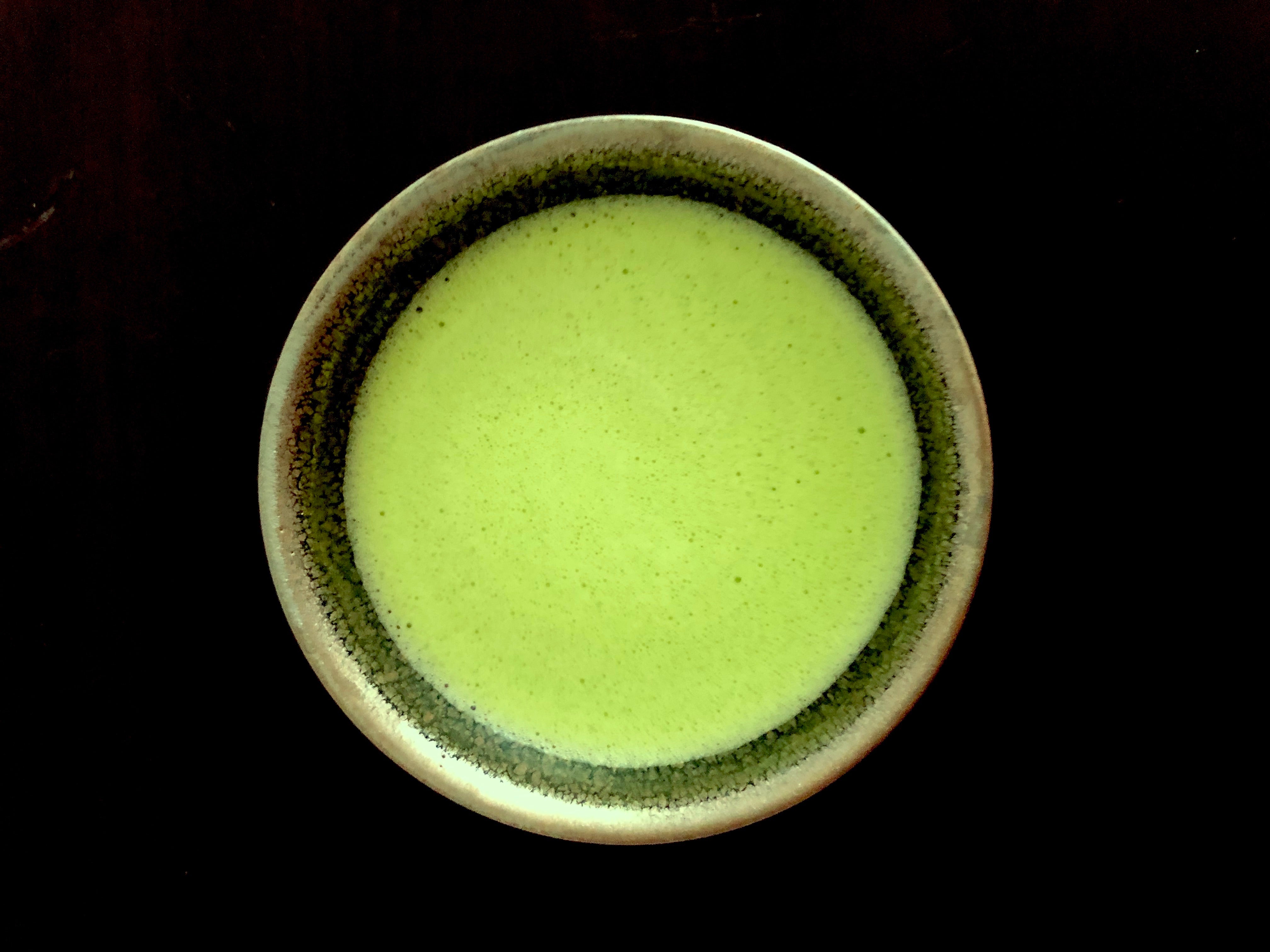 Honzu Asahi pinnacle grade ceremonial matcha green tea powder from Gokasho Uji Kyoto on tenmoku chawan top view sold by Sabo Tea Australia - Furukawa Seicha