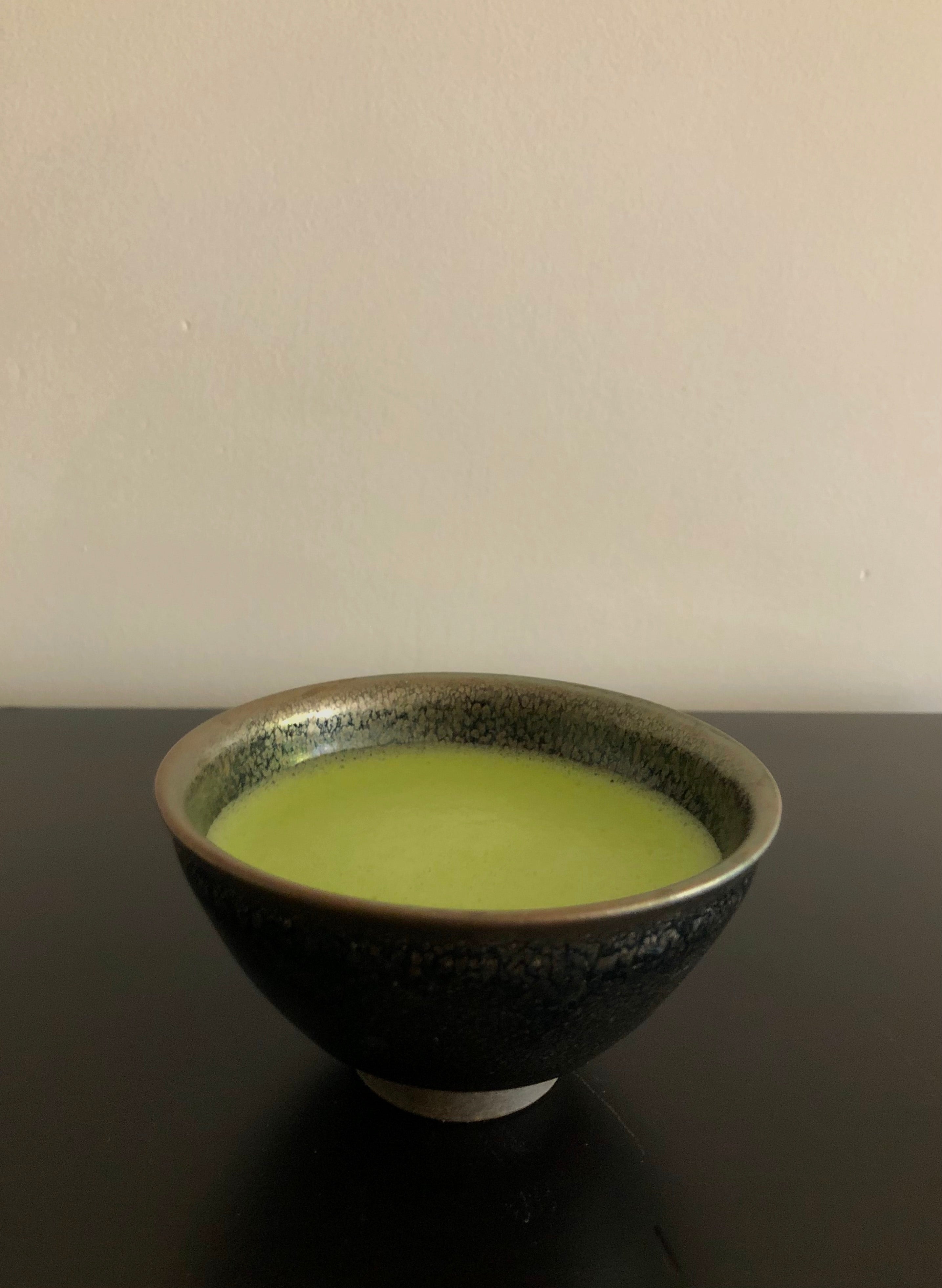 Honzu Asahi pinnacle grade ceremonial matcha green tea powder from Gokasho Uji Kyoto on tenmoku chawan side view sold by Sabo Tea Australia - Furukawa Seicha 